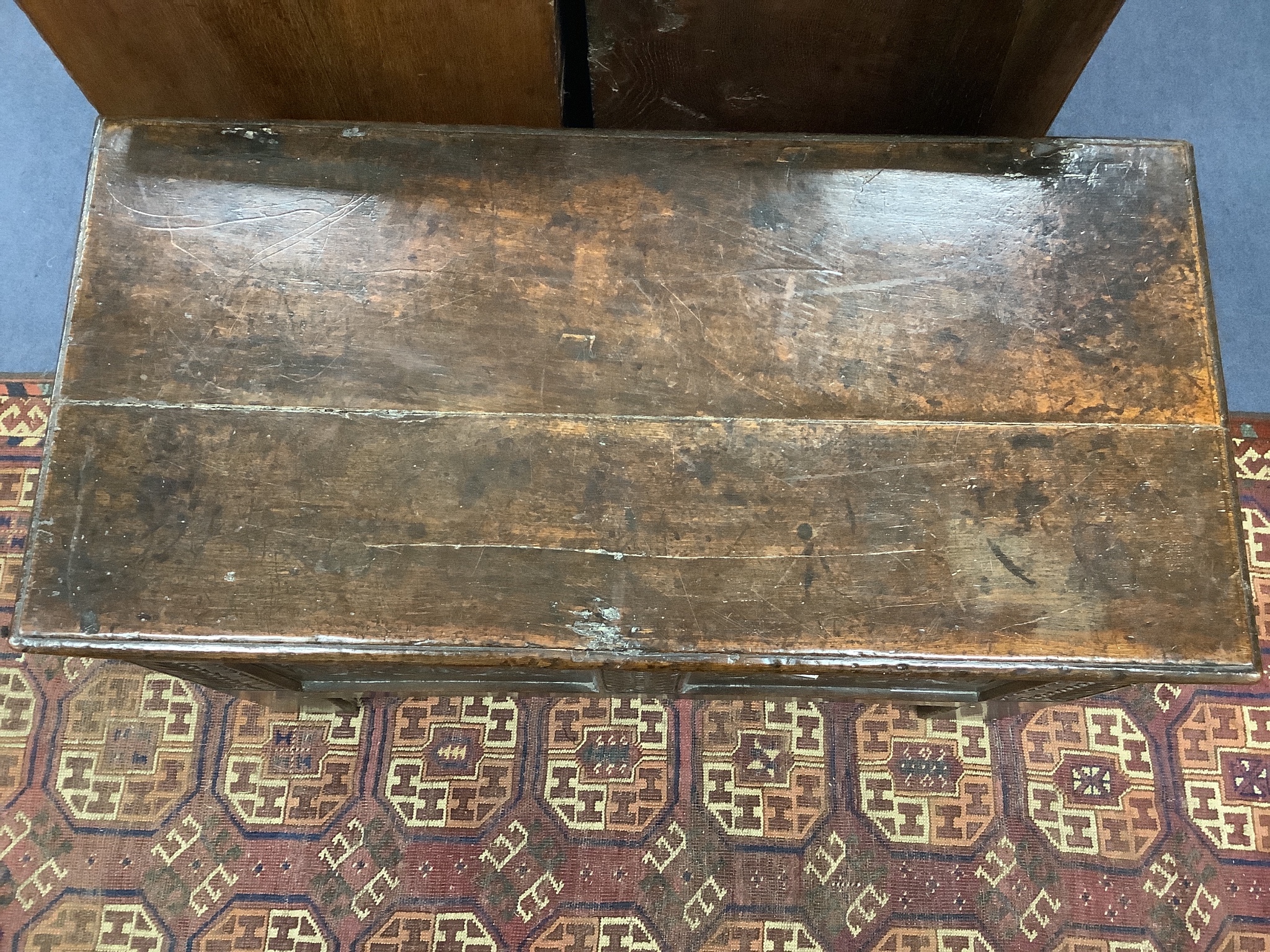 A 17th century carved boarded and panelled oak chest with rectangular moulded top, length 97cm, depth 48cm, height 64cm